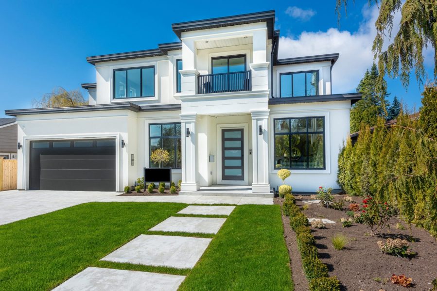 Beautiful,Contemporary,White,House,With,Lush,Grass,And,Blue,Sky