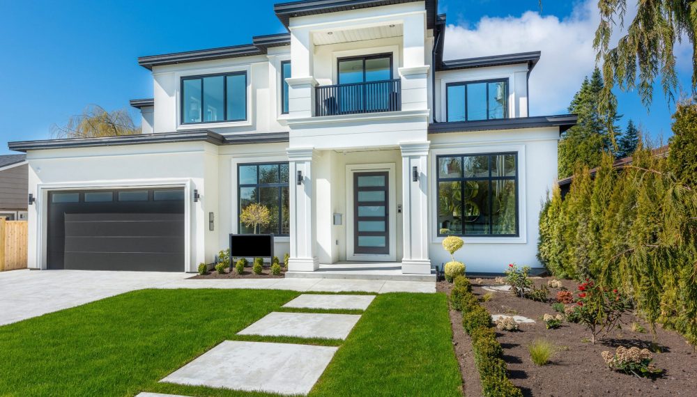 Beautiful,Contemporary,White,House,With,Lush,Grass,And,Blue,Sky